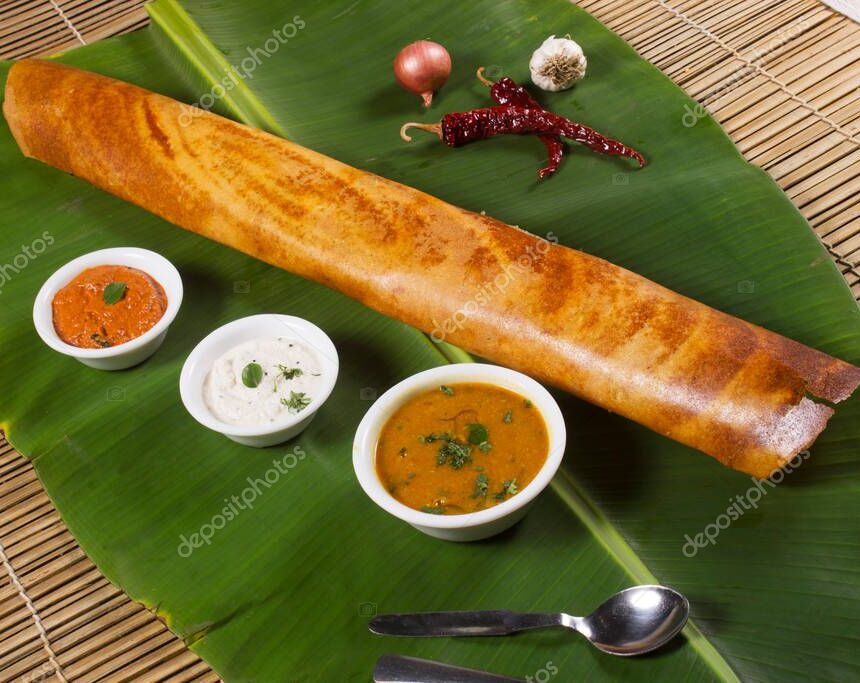 Masala dosa on banana leaf with both sambar and coconut chutney. South Indian Vegetarian Snack