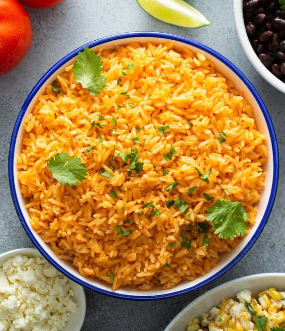 Mexican rice with tomatoes and onion served with cilantro